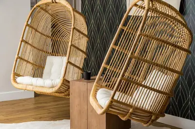 two wicker chairs sitting next to each other in a room at Spacious and Stylish Home with HotTub 12min to Downtown in Westminster