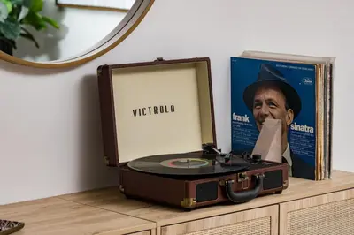 a cd in a suitcase on a dresser with a mirror at Spacious and Stylish Home with HotTub 12min to Downtown in Westminster