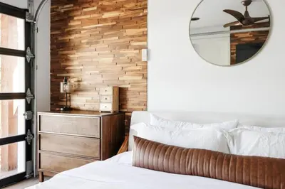 a bedroom with a white bed and a mirror at 5 Star Retreat With A Gym And APrivate Office in Thornton