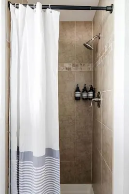 a shower with a white shower curtain in a bathroom at 5 Star Retreat With A Gym And APrivate Office in Thornton