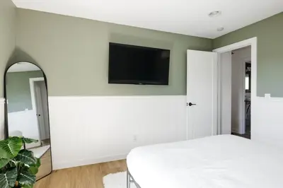 a bedroom with a bed and a flat screen tv on a wall at 5 Star Retreat With A Gym And APrivate Office in Thornton