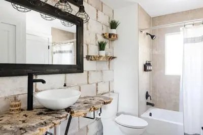 a bathroom with a sink and a toilet and a mirror at 5 Star Retreat With A Gym And APrivate Office in Thornton