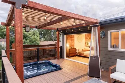 a patio with a hot tub on a deck at 5 Star Retreat With A Gym And APrivate Office in Thornton