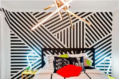 a bedroom with a black and white striped wall at Denver Hype House - 8 min to DT in Denver