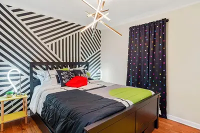 a bedroom with a bed with a striped ceiling at Denver Hype House - 8 min to DT in Denver