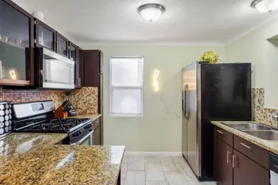 a kitchen with a black refrigerator and a sink at Denver Hype House - 8 min to DT in Denver