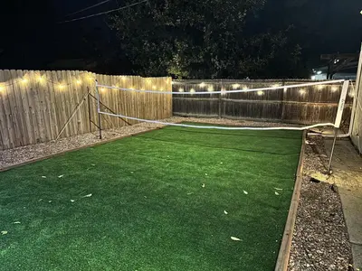 a volleyball net in a backyard at night at Denver Hype House - 8 min to DT in Denver
