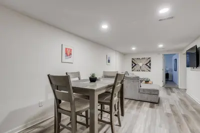 a dining room with a table and chairs and a couch at Spacious and Stylish Home With Fast Wifi and Near to Downtown in Denver