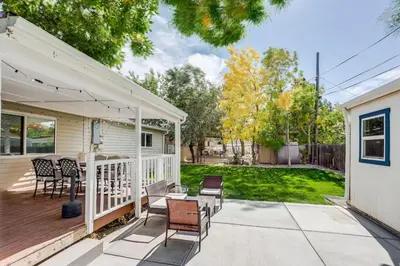 a porch with chairs and a table on a house at Spacious and Stylish Home With Fast Wifi and Near to Downtown in Denver
