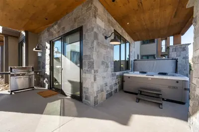 a bathroom with a bath tub and a sink at Downtown Fraser with Hot Tub in Fraser