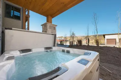 a large hot tub in a backyard at Downtown Fraser with Hot Tub in Fraser