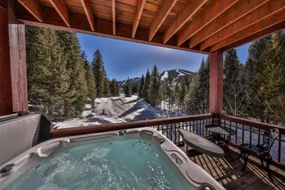 a hot tub on a balcony with a view of the mountains at Rocky Mountain Retreat Steps to Slopes with Hot Tub and Spectacular Views in Winter Park