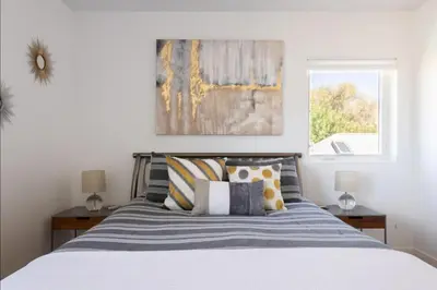a bedroom with a bed with pillows and a window at New Build and Pet Friendly Near to Highlands and RiNo in Denver