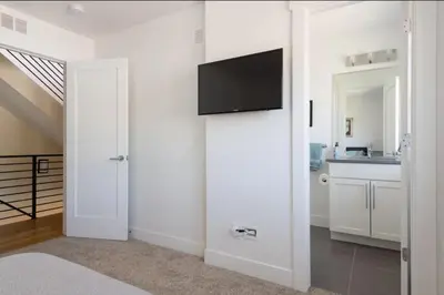 a white room with a flat screen tv on a wall at New Build and Pet Friendly Near to Highlands and RiNo in Denver