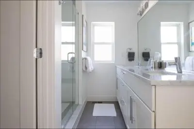 a white bathroom with a shower and a sink at New Build and Pet Friendly Near to Highlands and RiNo in Denver