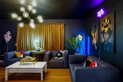 a living room with two blue couches and a table at 5 Bedroom Home 10 Min Drive To Downtown in Denver