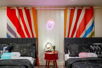 a room with two beds and an american flag banner at 5 Bedroom Home 10 Min Drive To Downtown in Denver