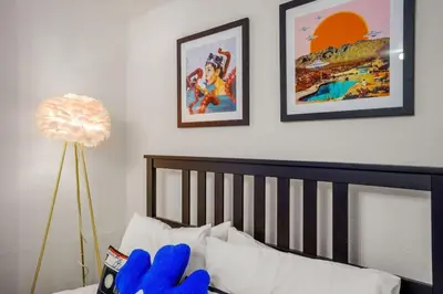 a bedroom with a bed with blue gloves on it at 5 Bedroom Home 10 Min Drive To Downtown in Denver