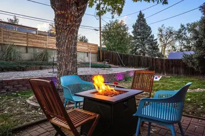 a fire pit in a yard with chairs and a tree at 5 Bedroom Home 10 Min Drive To Downtown in Denver