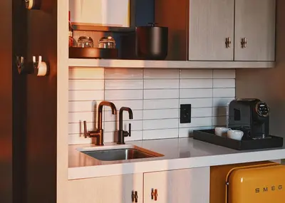 a kitchen with a sink and a microwave at Limelight Boulder in Boulder