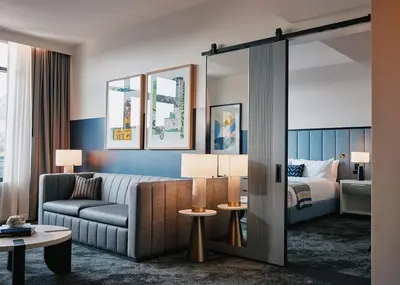 a hotel room with a couch and a bed at Limelight Boulder in Boulder