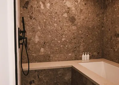 a bathroom with a bath tub and a sink at Limelight Boulder in Boulder