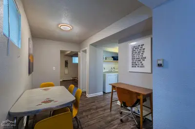 a room with a table and chairs and a kitchen at Charming 2 Bed Start Your Denver Adventure in Denver