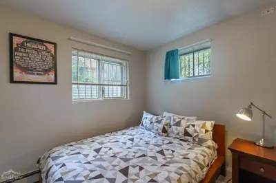 a bedroom with a bed and two windows at Charming 2 Bed Start Your Denver Adventure in Denver