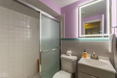 a bathroom with a toilet and a sink and a mirror at Charming 2 Bed Start Your Denver Adventure in Denver