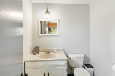 a bathroom with a sink and a toilet and a mirror at The Four Pines Near to Red Rocks And Morrison in Morrison
