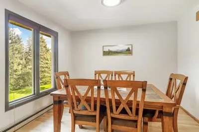 a dining room with a wooden table and chairs at The Four Pines Near to Red Rocks And Morrison in Morrison