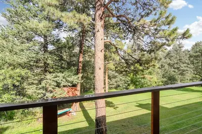 a view of a tree from a deck at The Four Pines Near to Red Rocks And Morrison in Morrison