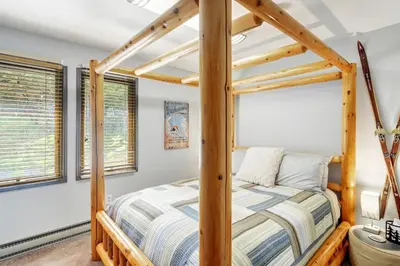 a bedroom with a bed with a wooden bed frame at The Four Pines Near to Red Rocks And Morrison in Morrison