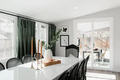 a dining room with a white table and chairs at Luxe Home with Hot Tub Movie Room and Firepit Near Denver in Arvada