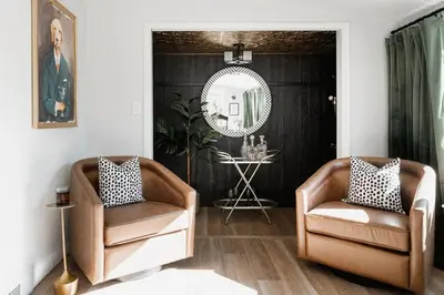 a living room with two chairs and a mirror at Luxe Home with Hot Tub Movie Room and Firepit Near Denver in Arvada