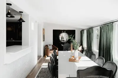 a dining room with a white table and chairs at Luxe Home with Hot Tub Movie Room and Firepit Near Denver in Arvada