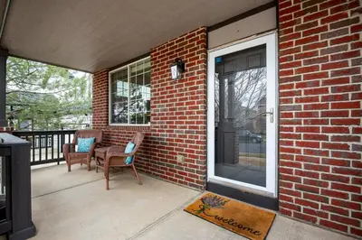 a patio with two chairs on a brick wall at 5 bed 4 bath and Pet friendly in Erie