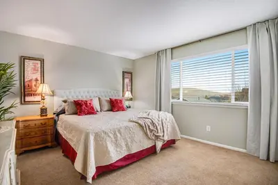 a bedroom with a bed and a large window at 5 bed 4 bath and Pet friendly in Erie