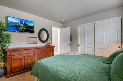 a bedroom with a bed and a tv on a wall at 5 bed 4 bath and Pet friendly in Erie