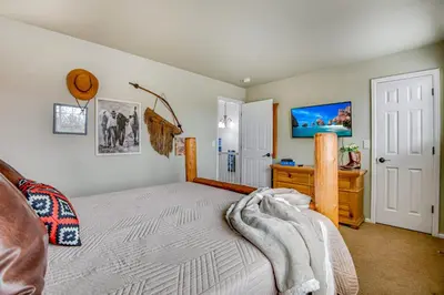 a bedroom with a bed and a tv on the wall at 5 bed 4 bath and Pet friendly in Erie