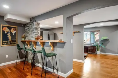 a kitchen with a bar with green stools at 5 bed 4 bath and Pet friendly in Erie