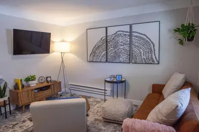 a living room with a couch and a tv at Zuni St Motor Inn- Bike, Dine, Explore Denver in Denver