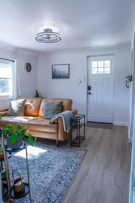 a living room with a couch and a door at Zuni St Motor Inn- Bike, Dine, Explore Denver in Denver