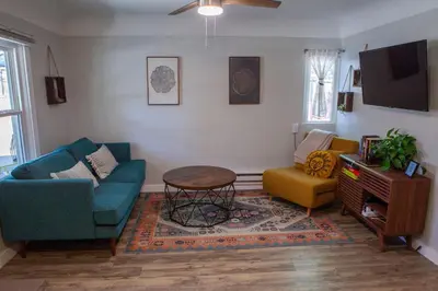 a living room with two chairs and a table at Zuni St Motor Inn- Bike, Dine, Explore Denver in Denver