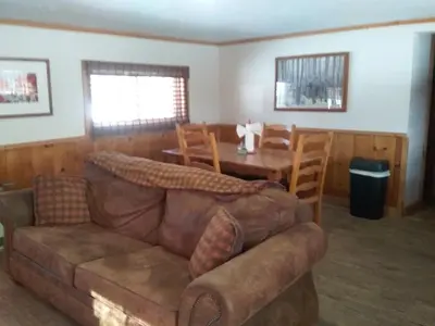 a living room with a couch and a table at Colorado Cabin Adventure in Grand Lake