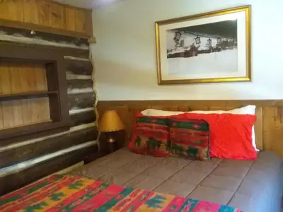 a bedroom with a bed and a picture on the wall at Colorado Cabin Adventure in Grand Lake