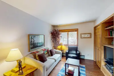 a living room with a couch and a chair at Blue Riverfront Retreat in Silverthorne