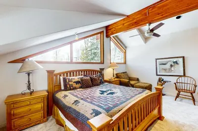 a bedroom with a bed and a window at Blue Riverfront Retreat in Silverthorne