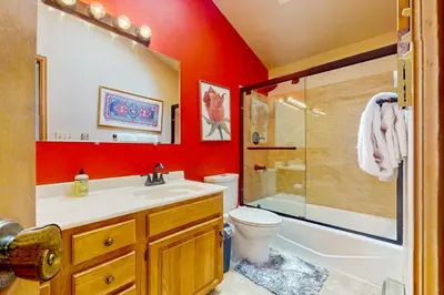 a bathroom with a toilet and a shower and a sink at Blue Riverfront Retreat in Silverthorne