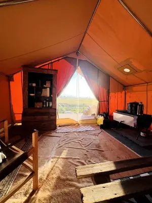 an orange tent with a large window in it at Colorado Getaways in this Lovely Safari Tent on Working Sheep Farm in Longmont in Longmont